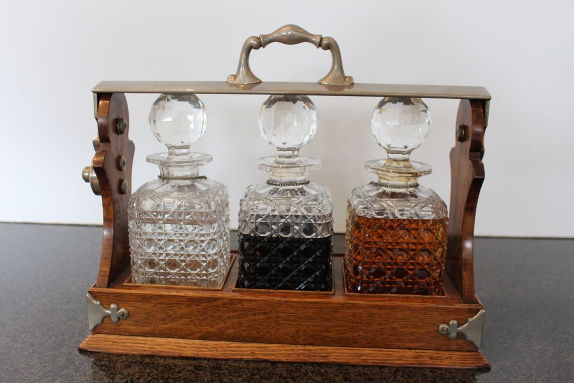 Antique English Oak Tantalus with Three Cut Crystal Decanters, c. late 1800s