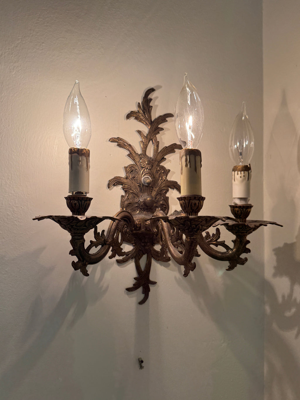 Pair of Vintage Bronze Three Arm Wall Sconces with White Candlesticks