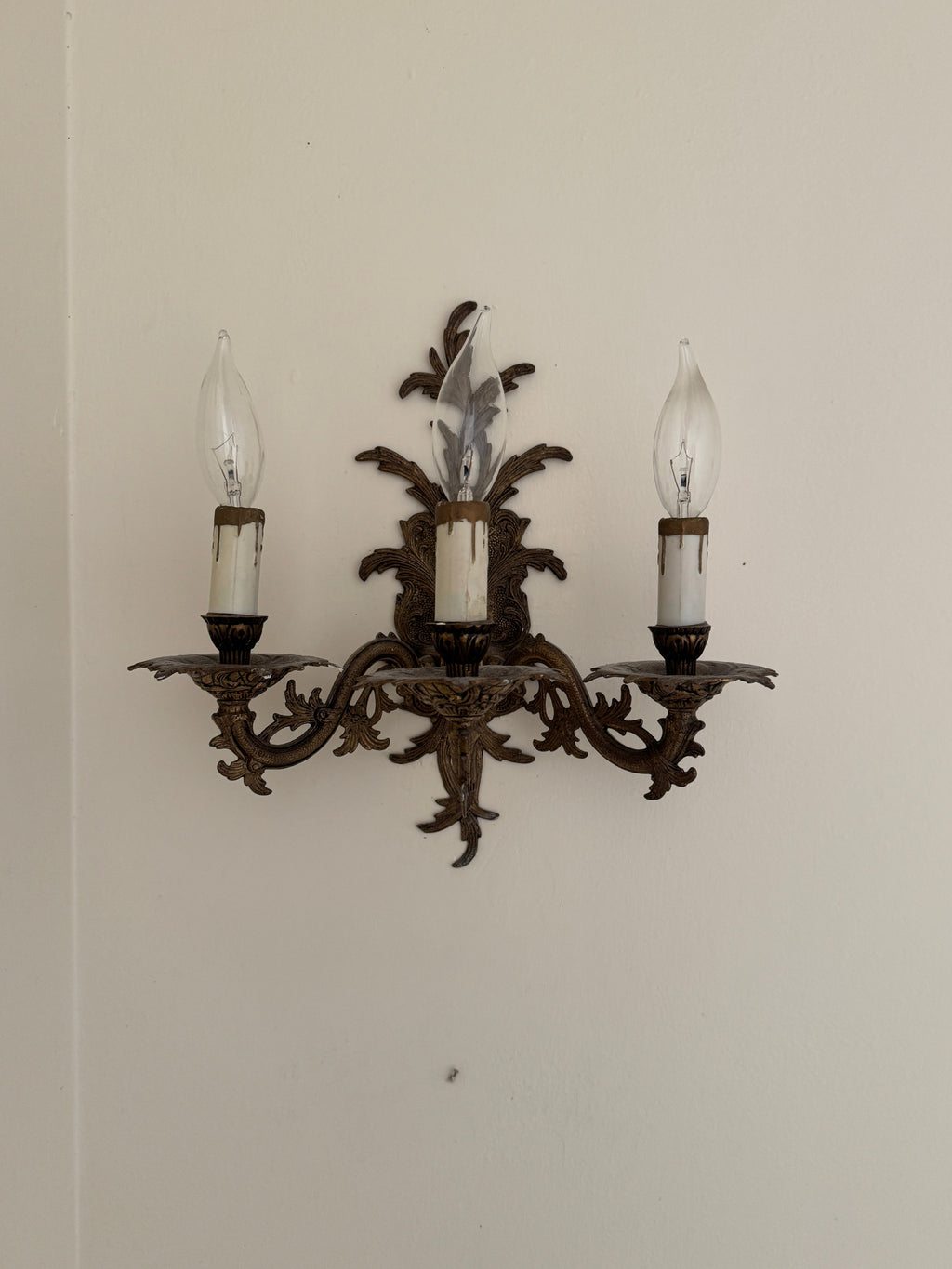 Pair of Vintage Bronze Three Arm Wall Sconces with White Candlesticks