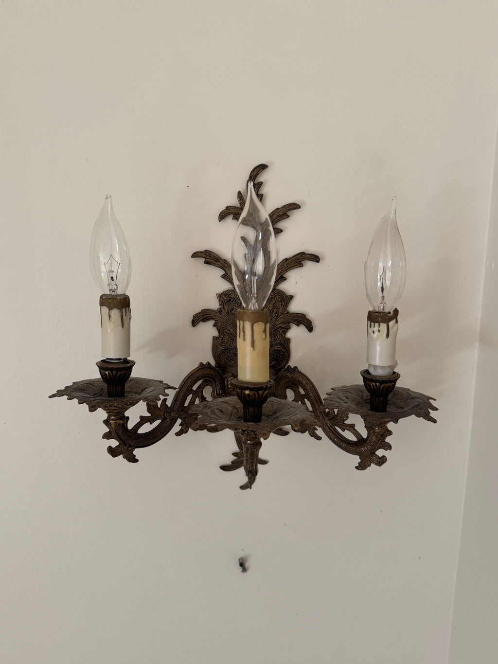Pair of Vintage Bronze Three Arm Wall Sconces with White Candlesticks